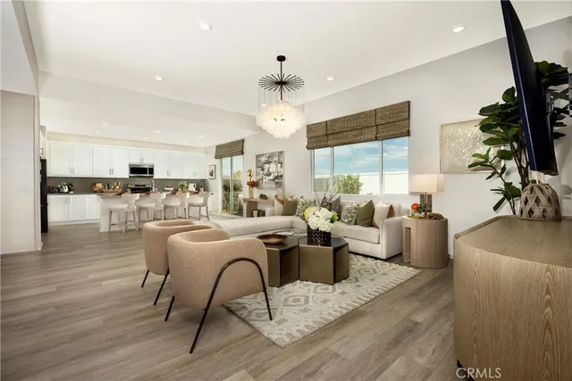 a living room with furniture or chandelier and a wooden floor
