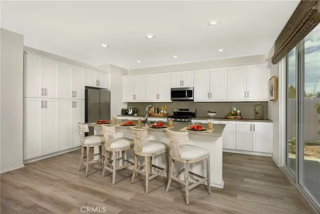 a kitchen with stainless steel appliances a stove a sink refrigerator and a microwave