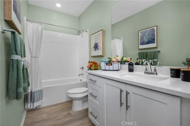 a bathroom with a sink a toilet and a large mirror