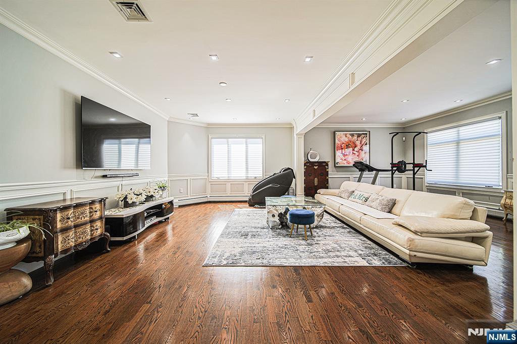 897 Virgil Avenue Ridgefield, NJ 07657 - Photo 10 of 50 a living room with fireplace furniture and a flat screen tv
