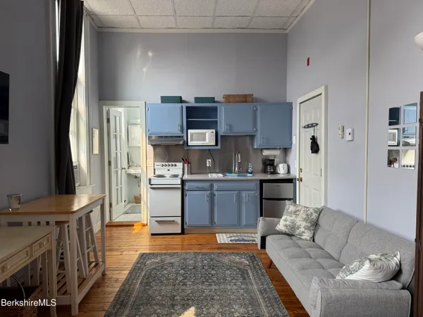 a kitchen with stainless steel appliances granite countertop a refrigerator sink and stove