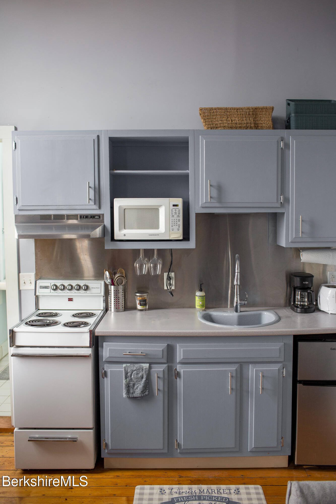 19 Church Street, Unit 11 North Adams, MA 01247 - Photo 6 of 8 a kitchen with stainless steel appliances granite countertop a sink stove and cabinets