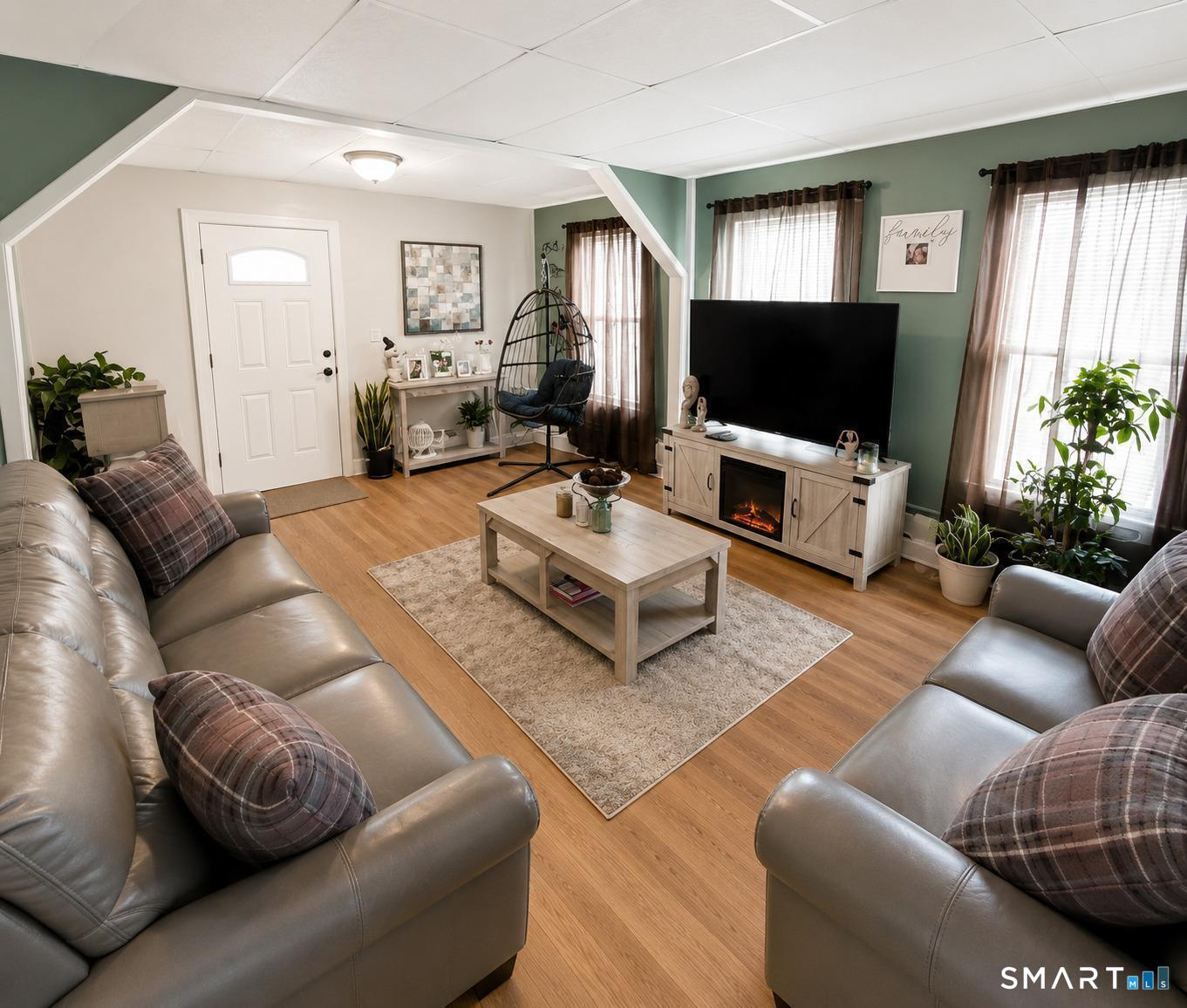 61 Bartlett Street Meriden, CT 06451 - Photo 21 of 30 a living room with furniture and a flat screen tv