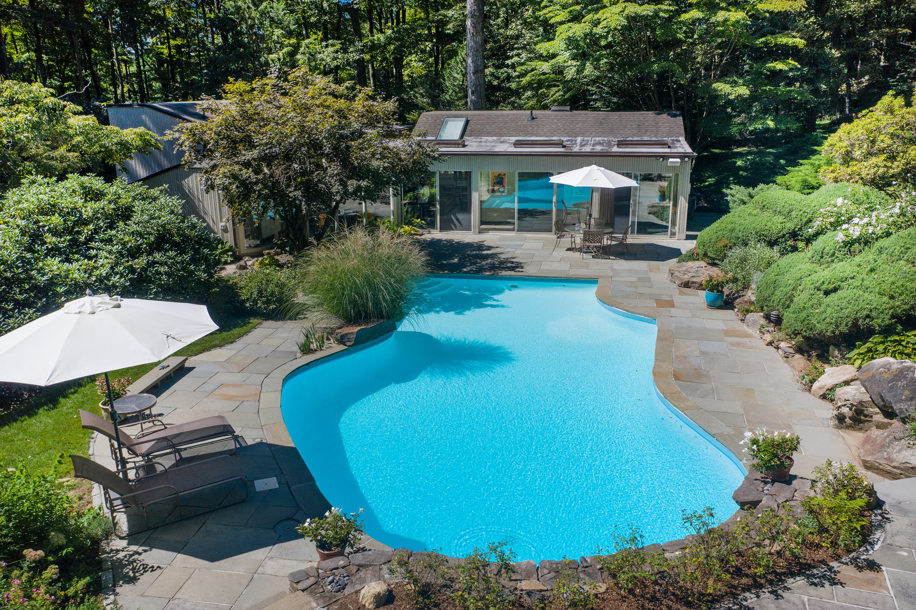 46 Chalburn Road Redding, CT 06896 - Photo 33 of 39 a view of a backyard with table and chairs under an umbrella