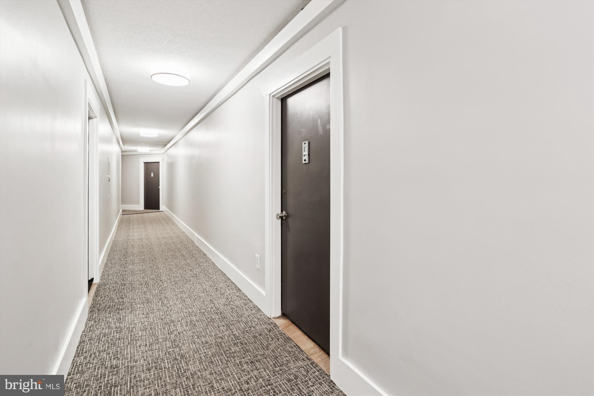 4000 Tunlaw Road Northwest, Unit 619 Washington, DC 20007 - Photo 20 of 39 a view of a hallway with wooden floor