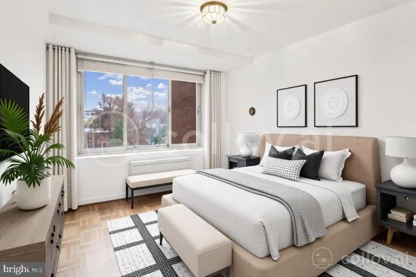 a bedroom with a large bed and a large window