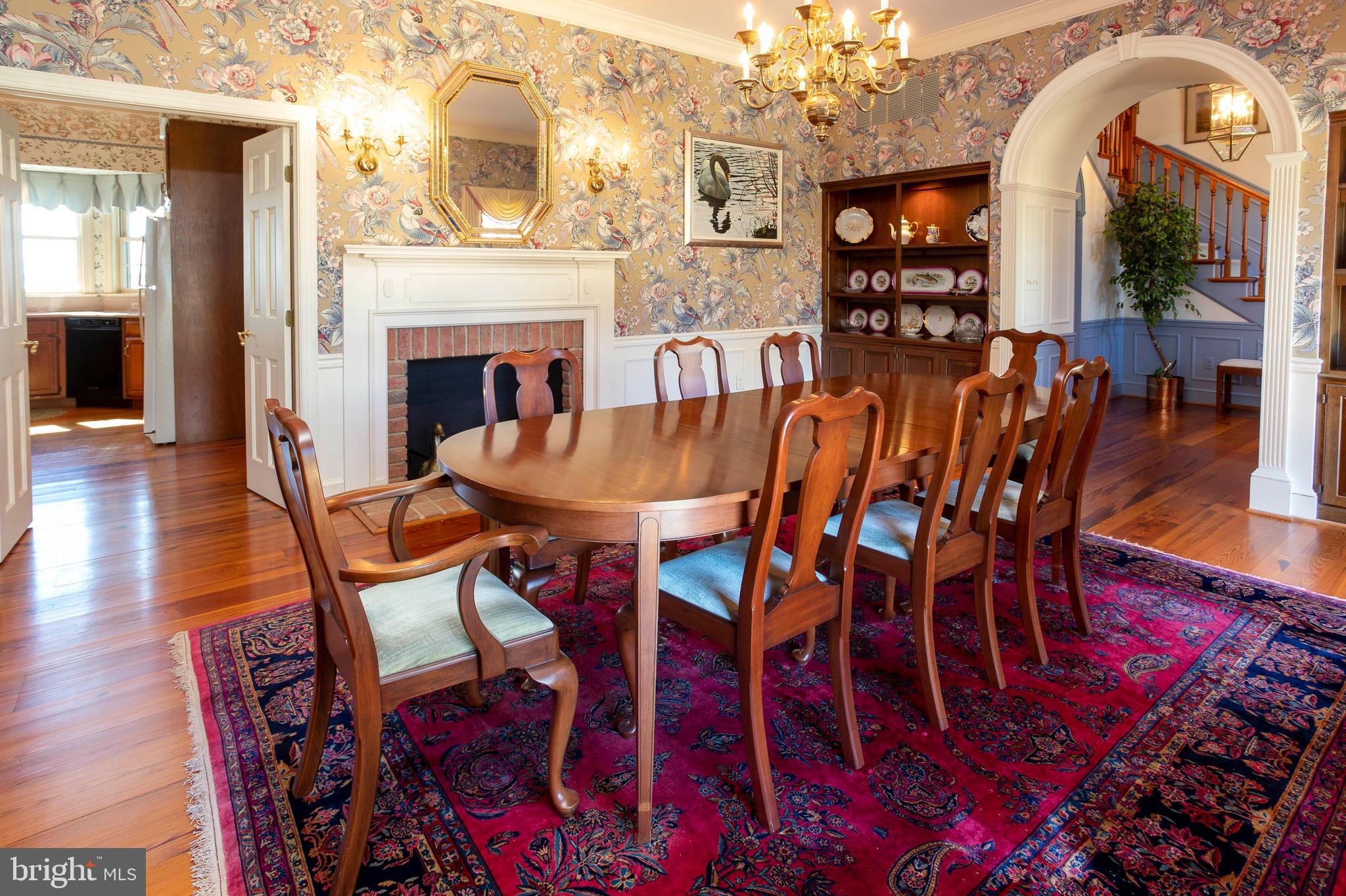 26107 Goose Neck Road Royal Oak, MD 21662 - Photo 15 of 50 Dining room with fireplace and arched doorway