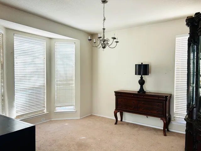 a view of a room with a window and ceiling fan