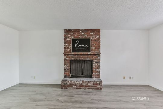 922 West Wasp Avenue Ridgecrest, CA 93555 - Photo 3 of 31 a living room with a fireplace