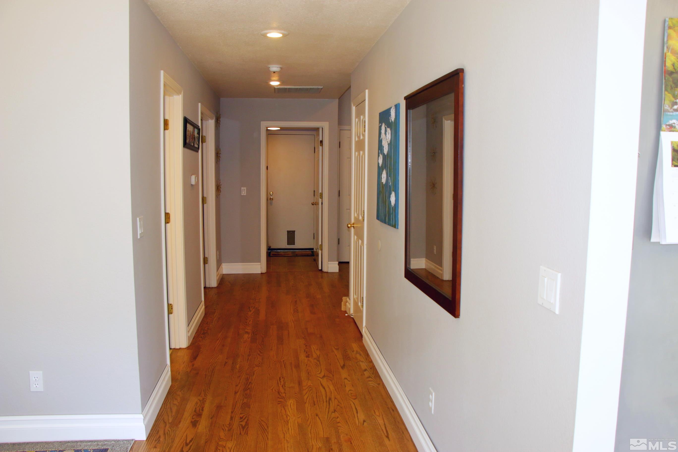 5330 Butterfly Court Reno, NV 89523 - Photo 11 of 34 a view of a hallway with wooden floor