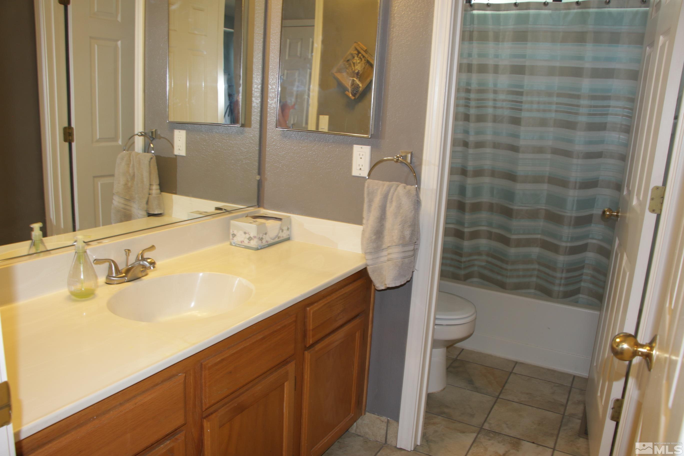 5330 Butterfly Court Reno, NV 89523 - Photo 13 of 34 a bathroom with a sink and a mirror
