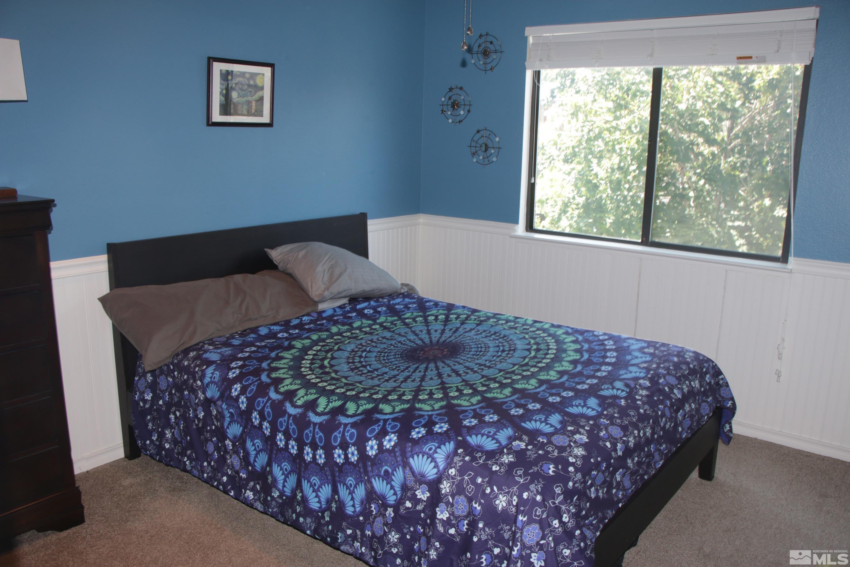 5330 Butterfly Court Reno, NV 89523 - Photo 21 of 34 a bed sitting in a bedroom next to a window