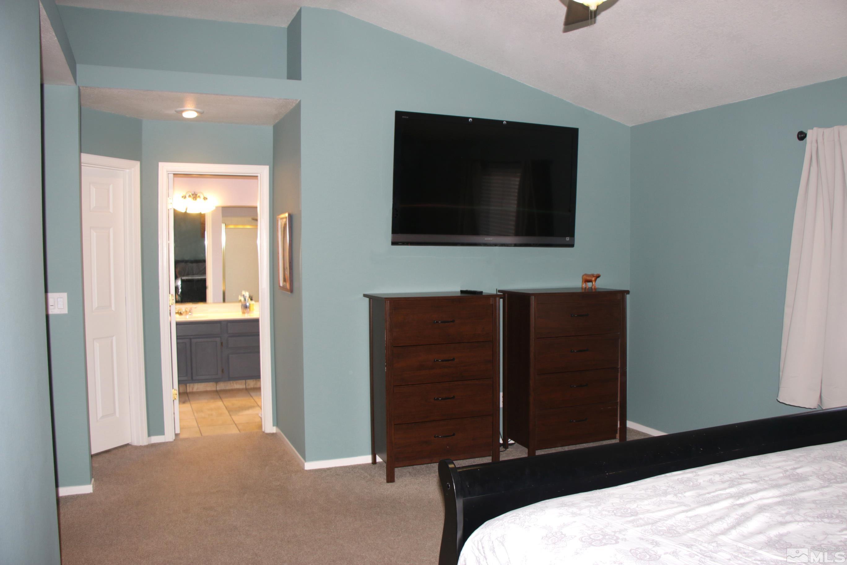 5330 Butterfly Court Reno, NV 89523 - Photo 24 of 34 a bedroom with a bed and a flat screen tv
