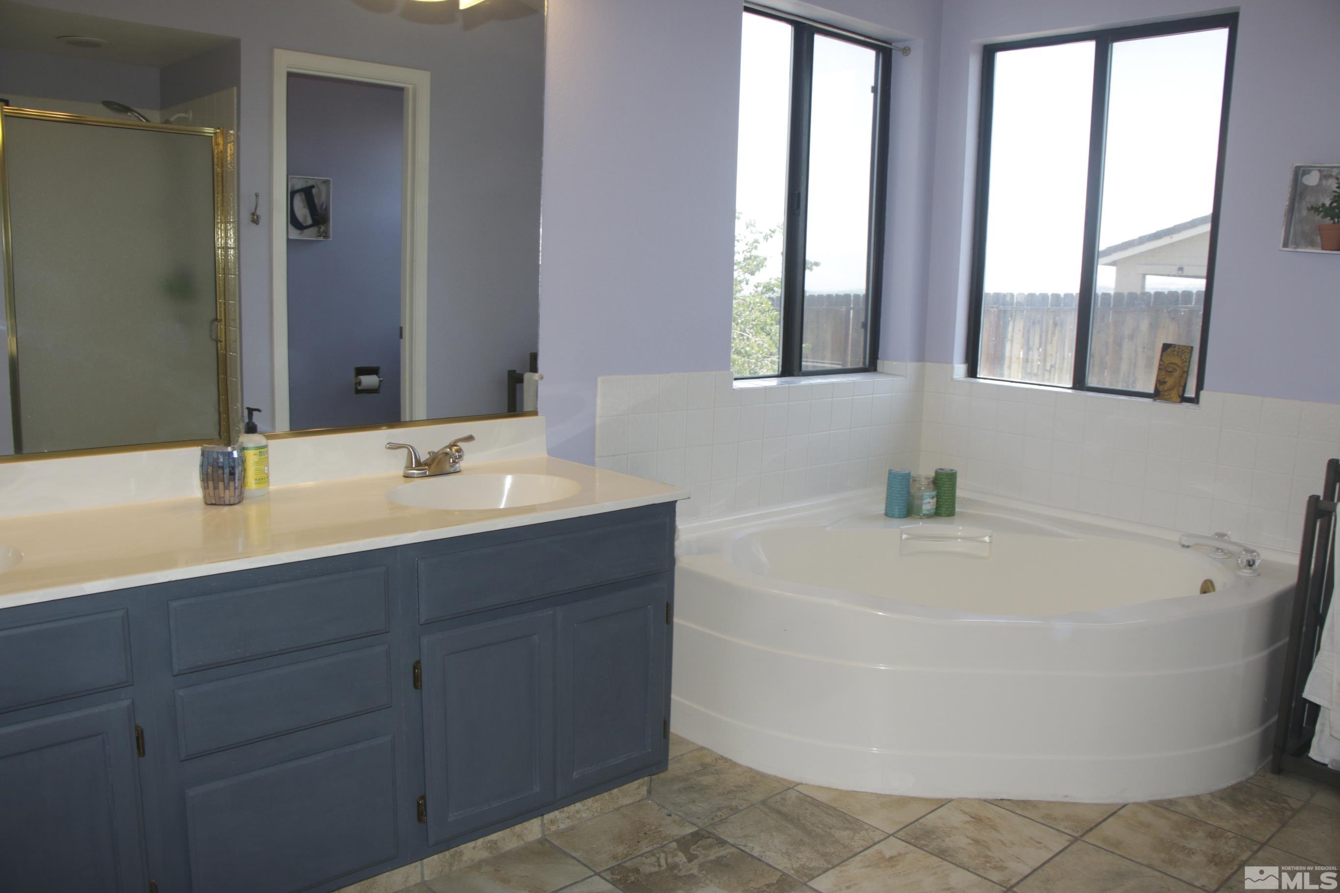 5330 Butterfly Court Reno, NV 89523 - Photo 26 of 34 a bathroom with a tub a sink and a window