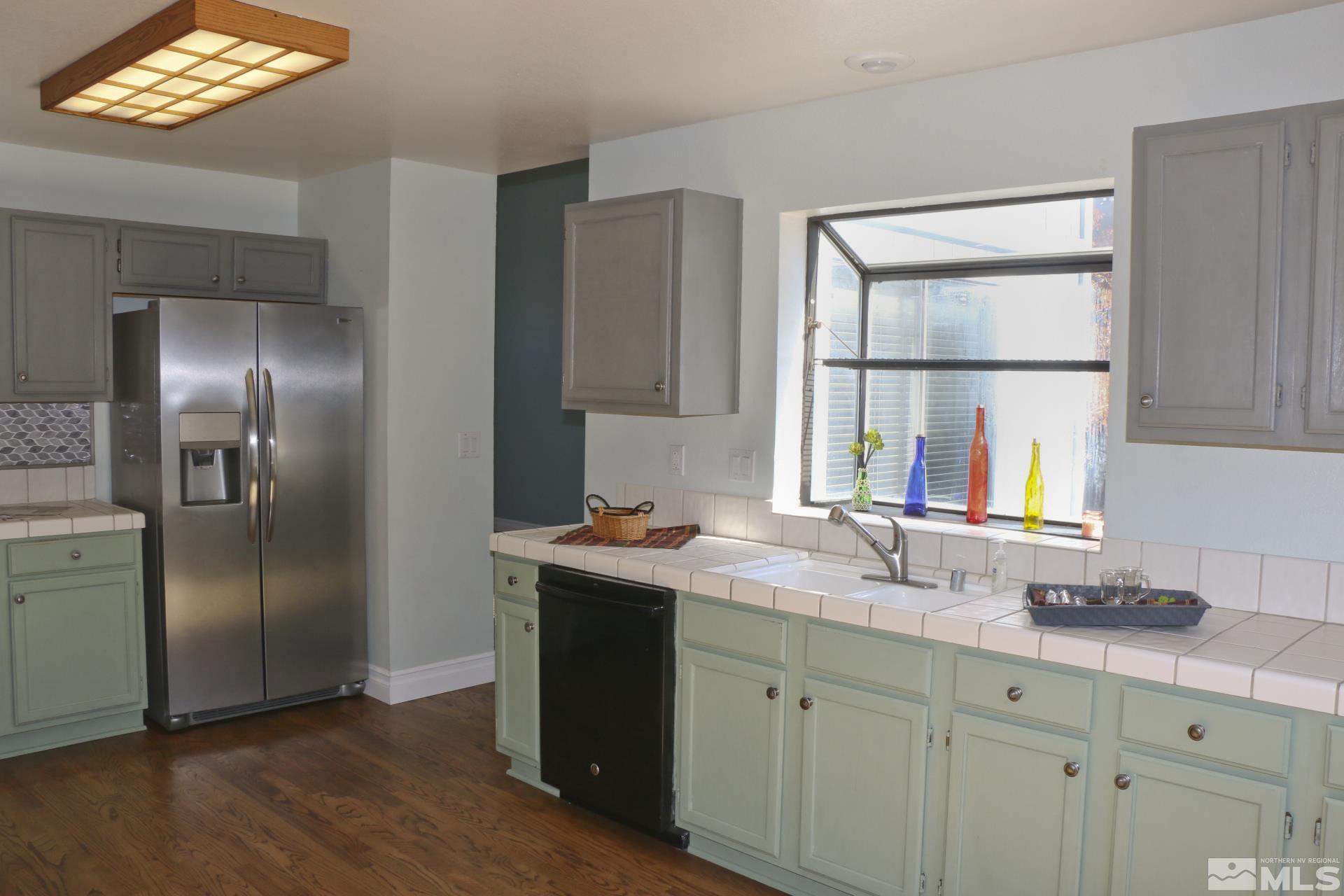 5330 Butterfly Court Reno, NV 89523 - Photo 8 of 34 a kitchen with stainless steel appliances granite countertop a refrigerator and a sink