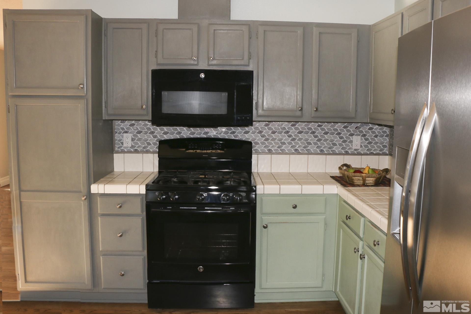 5330 Butterfly Court Reno, NV 89523 - Photo 10 of 34 a kitchen with granite countertop a stove and a microwave
