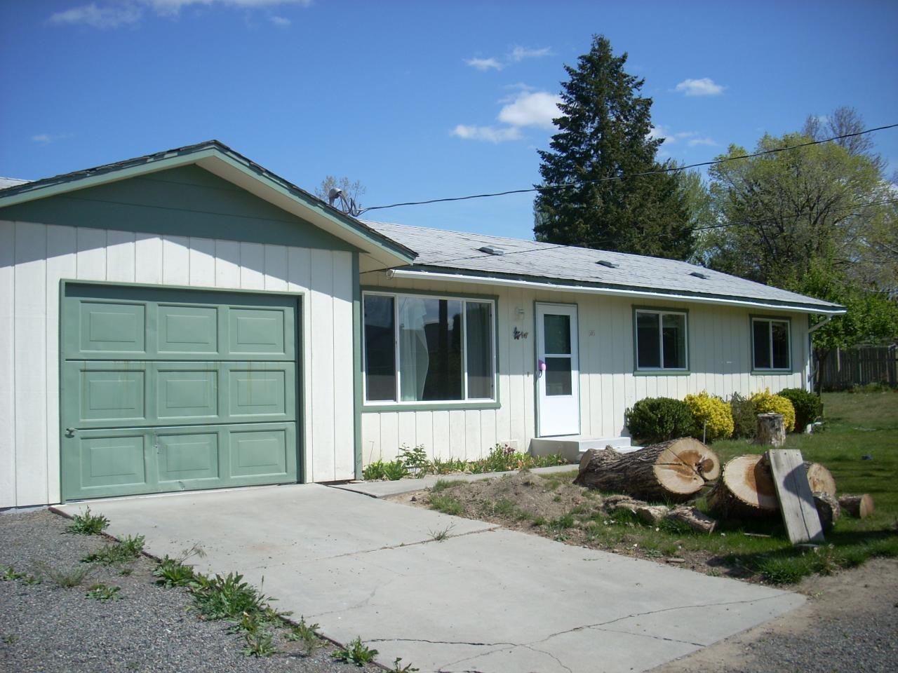 505 Butternut Road Grandview, WA 98930 - Photo 1 of 1 a front view of a house with a garden and plants