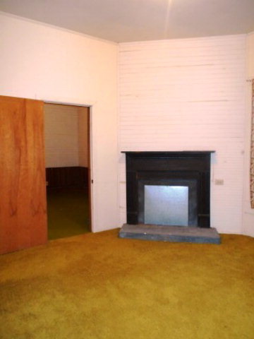 3076 Stokes Store Road Forsyth, GA 31029 - Photo 5 of 11 a view of an empty room with window and fireplace