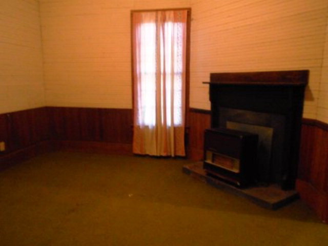 3076 Stokes Store Road Forsyth, GA 31029 - Photo 6 of 11 a view of empty room with a fireplace