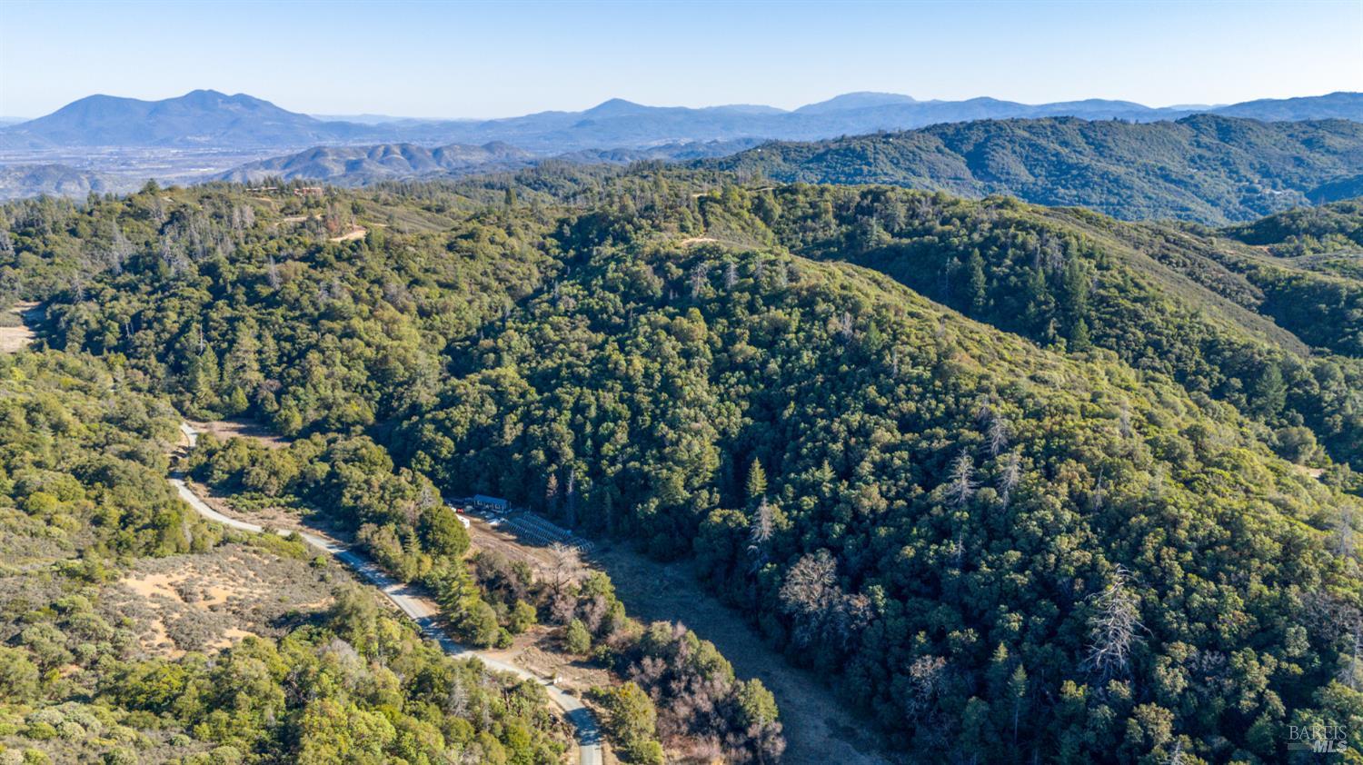 3681 Benmore Valley Road Hopland, CA 95449 - Photo 4 of 20 a view of a lush green hillside and a houses