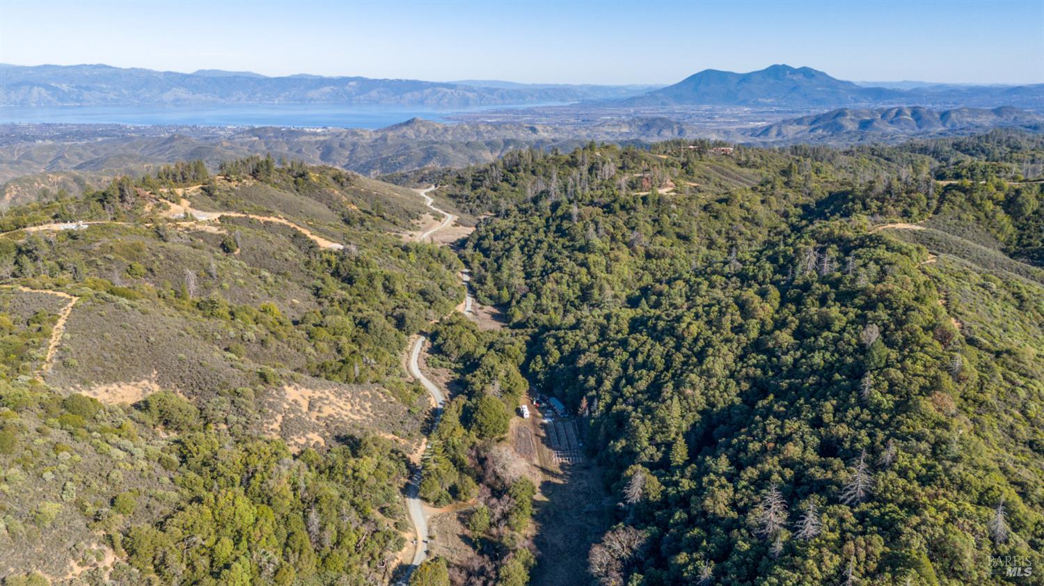 3681 Benmore Valley Road Hopland, CA 95449 - Photo 5 of 20 a view of a lush green hillside and a houses