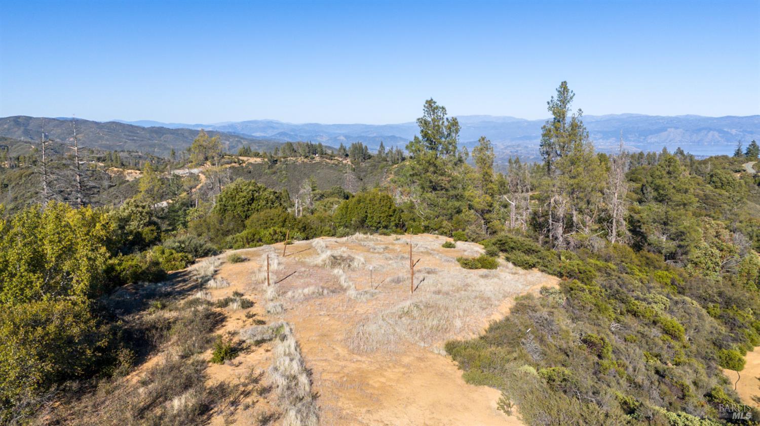 3681 Benmore Valley Road Hopland, CA 95449 - Photo 7 of 20 a view of a dry yard with mountains in the background