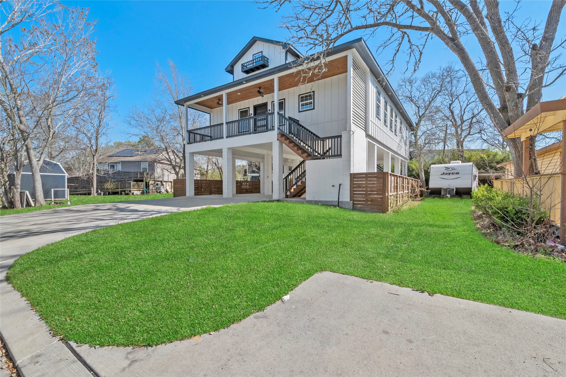 3133 Hamilton Street La Porte, TX 77571 - Photo 2 of 24 a view of a white house next to a yard with big trees