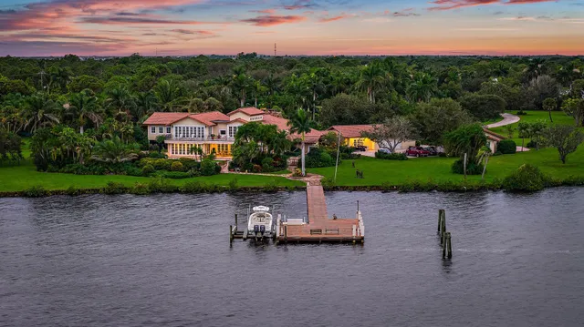 an aerial view of a house with a lake view