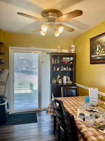 a view of a dining room with furniture and wooden floor