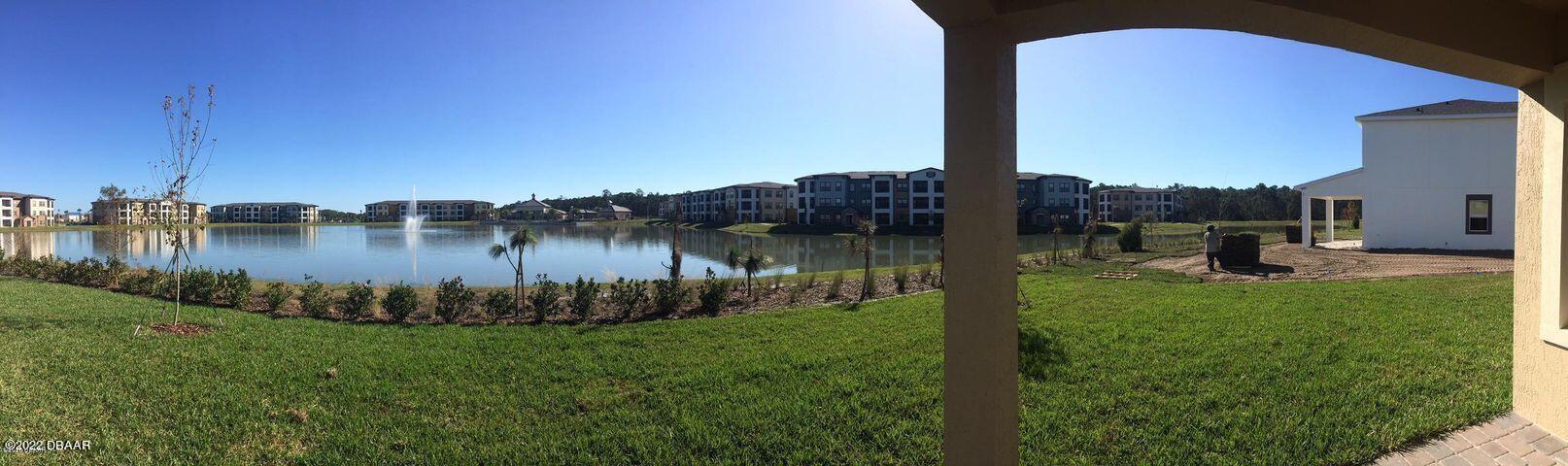 5435 Estero Loop Port Orange, FL 32128 - Photo 6 of 17 a view of a lake with a yard
