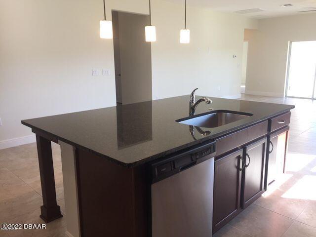 5435 Estero Loop Port Orange, FL 32128 - Photo 7 of 17 a kitchen with stainless steel appliances granite countertop a sink a refrigerator and a granite counter tops