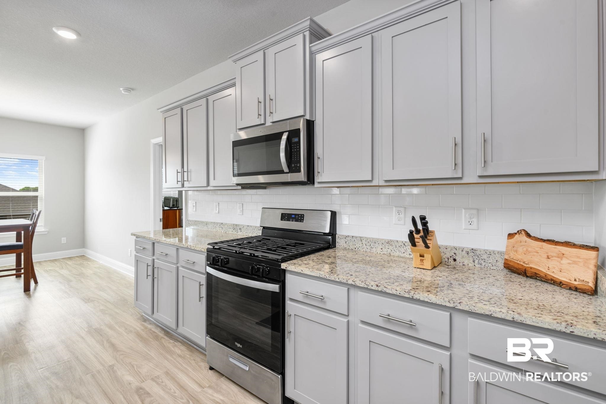 2183 Meadowview Loop Semmes, AL 36575 - Photo 39 of 58 Kitchen with stainless steel appliances, tasteful backsplash, light wood finished floors, and light stone countertops