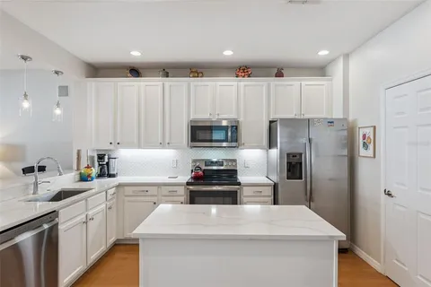 a kitchen with a sink a stove and refrigerator
