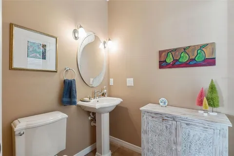 a bathroom with a sink mirror and toilet