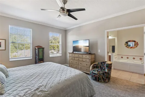 a bedroom with furniture and a flat screen tv