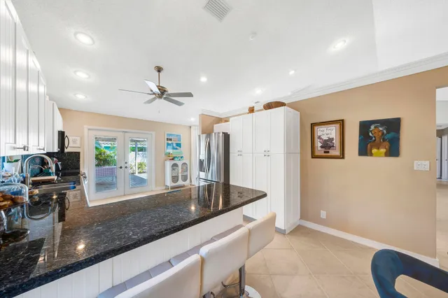 a view of a kitchen with stainless steel appliances granite countertop a refrigerator and a sink
