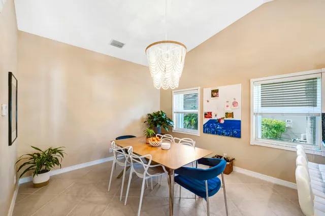 a view of a dining room with furniture and window