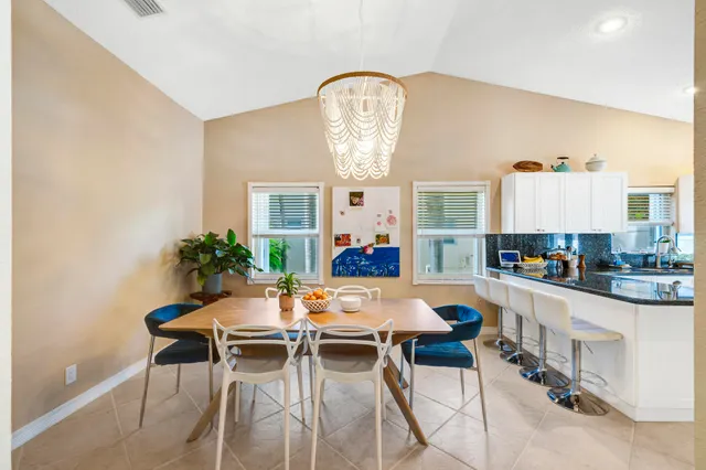 a view of a dining room with furniture and a chandelier