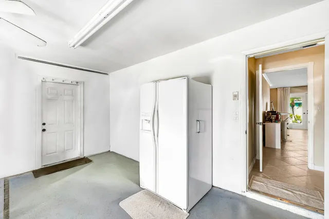 a view of a hallway with bathroom and a glass door
