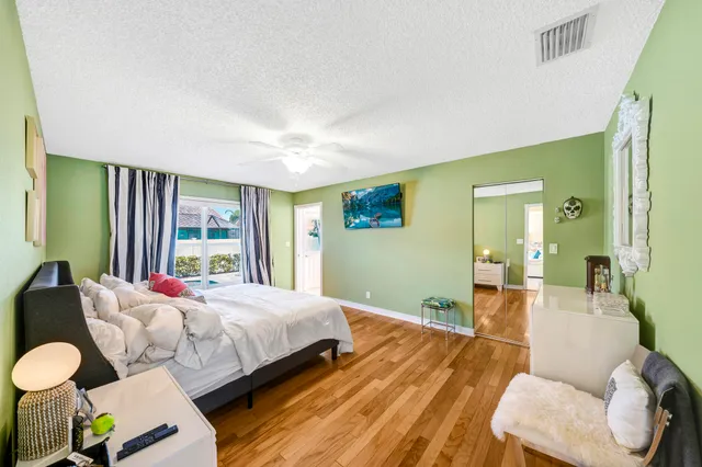 a bedroom with bed and a large window