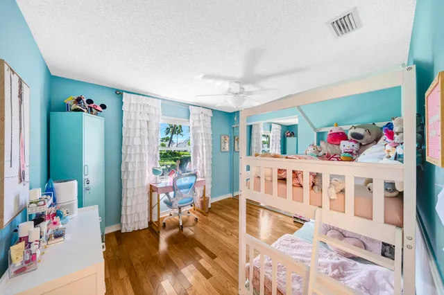 a living room with furniture and a baby crib