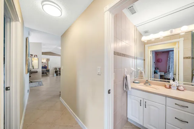 a en suite bathroom with a sink mirror and shower
