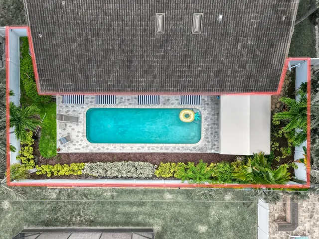 an aerial view of residential houses with outdoor space and street view