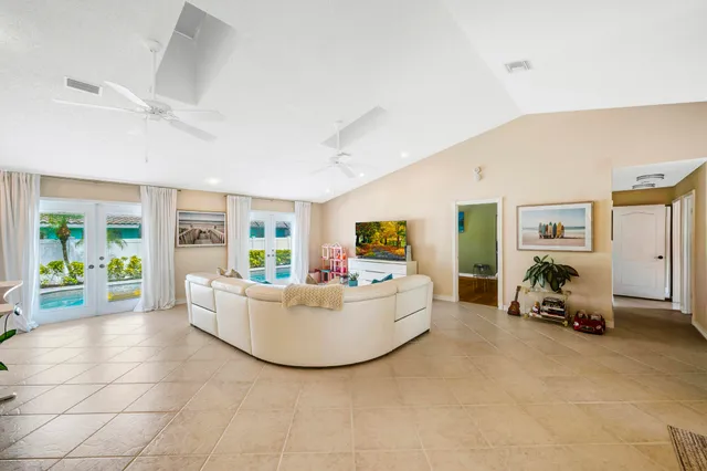 a living room with furniture and large windows