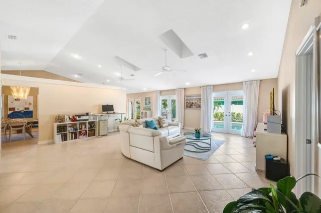 a living room with fireplace furniture and a large window