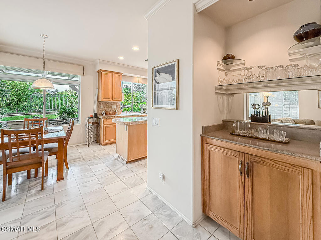 260 Sycamore Ridge Street Simi Valley, CA 93065 - Photo 19 of 58 a kitchen with kitchen island granite countertop a table chairs sink and cabinets