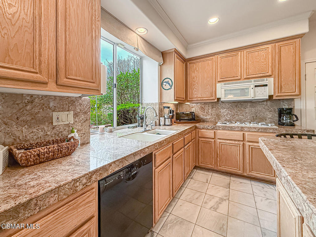 260 Sycamore Ridge Street Simi Valley, CA 93065 - Photo 21 of 58 a kitchen with a sink window and cabinets