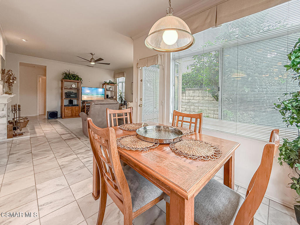 260 Sycamore Ridge Street Simi Valley, CA 93065 - Photo 22 of 58 a dining room with furniture a chandelier and wooden floor