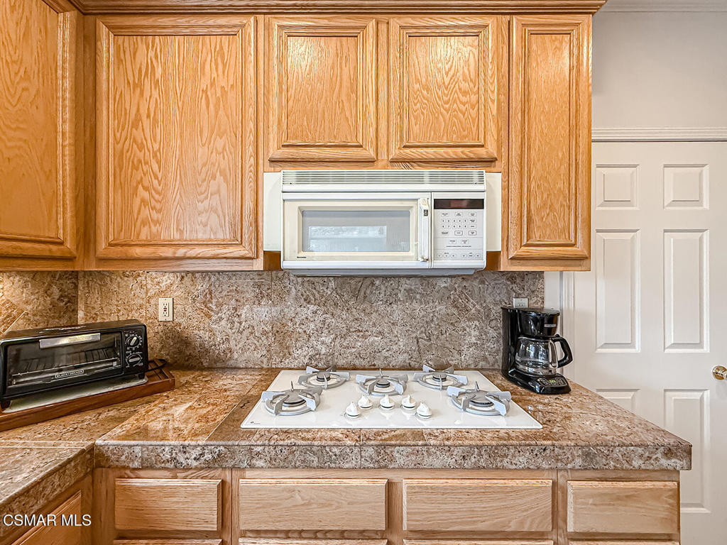 260 Sycamore Ridge Street Simi Valley, CA 93065 - Photo 24 of 58 a kitchen with a stove a sink and cabinets