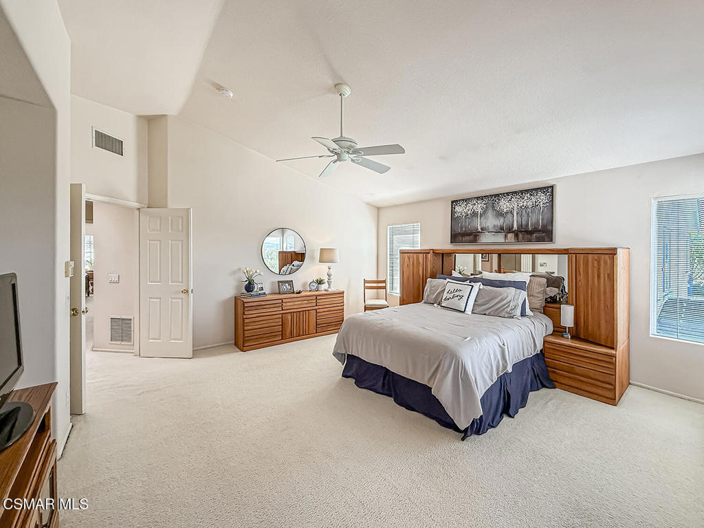 260 Sycamore Ridge Street Simi Valley, CA 93065 - Photo 35 of 58 a spacious bedroom with a bed a dresser and a chandelier